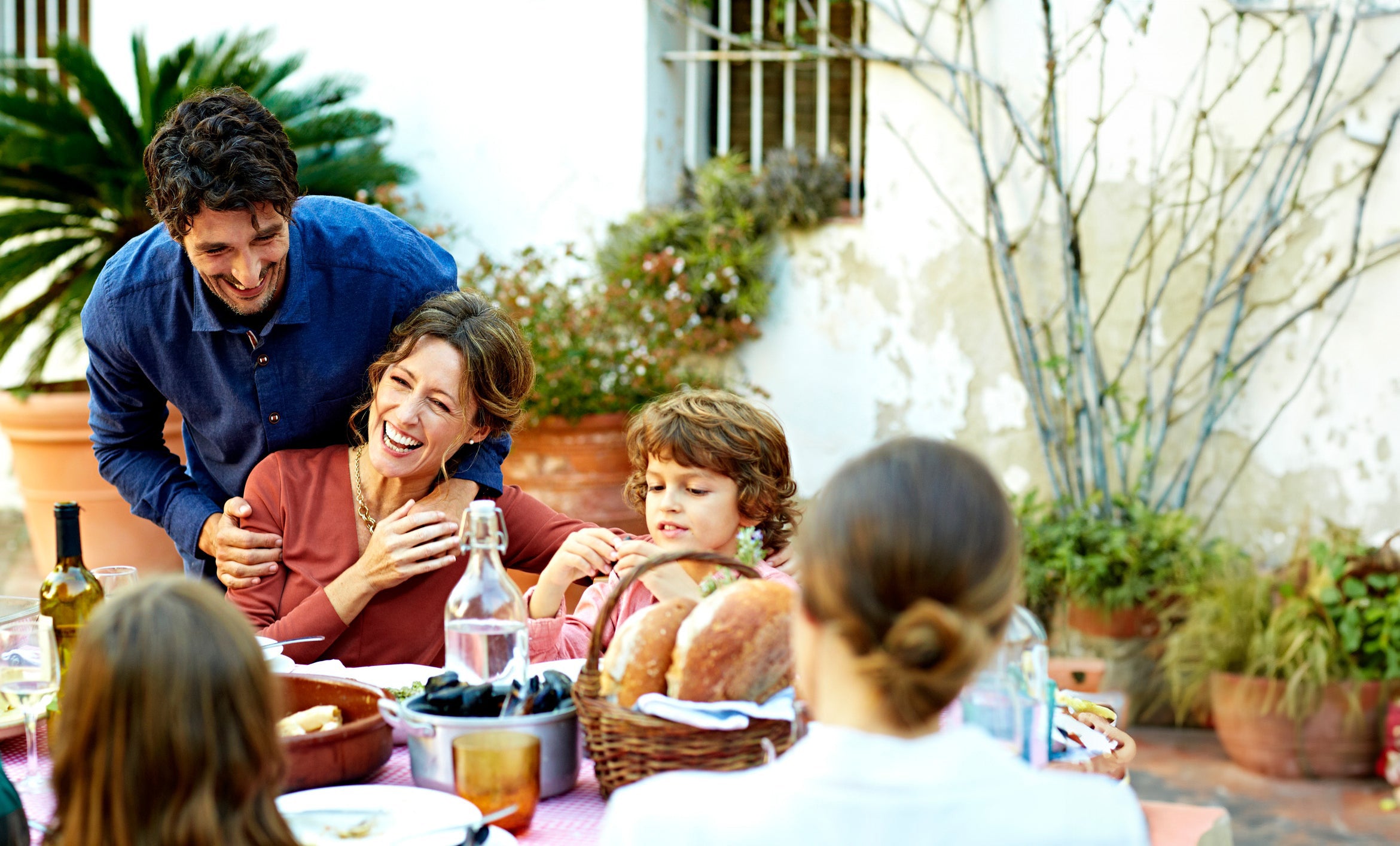 family eating around a table outdoors